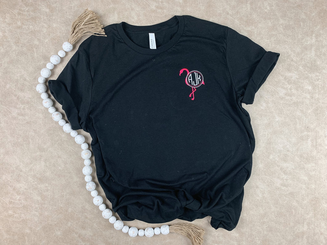 Black Bella Canvas soft style t-shirt with neon pink flamingo monogram on left chest