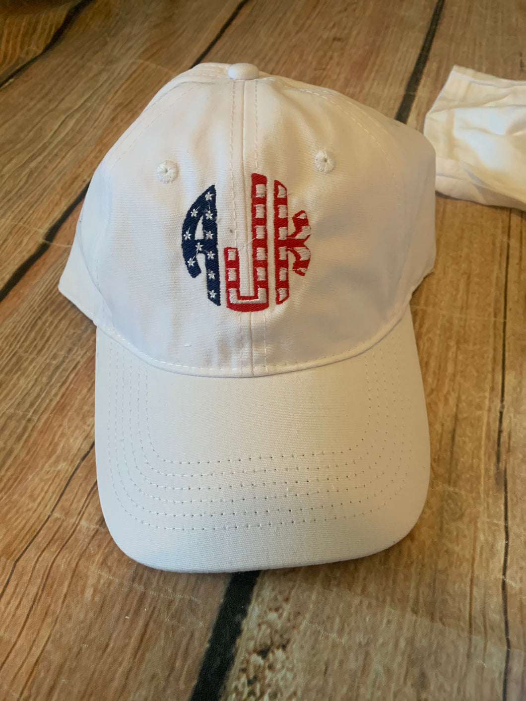 White unstructured, adjustable hat with American Flag monogram